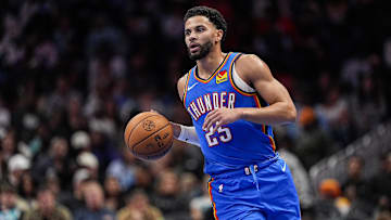 Nov 15, 2025; Charlotte, North Carolina, USA; Oklahoma City Thunder guard Ajay Mitchell (25) brings the ball up court against the Charlotte Hornets during the second half at Spectrum Center. Mandatory Credit: Jim Dedmon-Imagn Images
