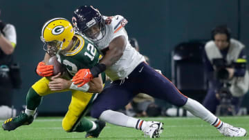 Chicago Bears defensive end Al-Quadin Muhammad (55) tackles scrambling Green Bay Packers quarterback