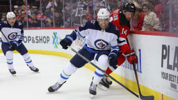 Winnipeg Jets defenseman Brenden Dillon (5) and New Jersey Devils right wing Nathan Bastian (14). Mandatory Credit: Ed Mulholland-USA TODAY Sports