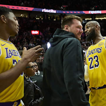 Feb 20, 2025; Portland, Oregon, USA; Los Angeles Lakers forward LeBron James (23) celebrates with guard Luka Doncic (77) and forward Rui Hachimura (28) after beating the Portland Trail Blazers at Moda Center. Mandatory Credit: Troy Wayrynen-Imagn Images