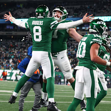 Jan 5, 2025; East Rutherford, New Jersey, USA; New York Jets quarterback Aaron Rodgers (8) celebrates his touchdown pass to New York Jets wide receiver Davante Adams (17) (not pictured) during the fourth quarter of their game against the Miami Dolphins at MetLife Stadium. Mandatory Credit: Ed Mulholland-Imagn Images