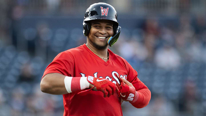 Woo Sox catcher Ronaldo Hernandez smiles while taking his batting gloves off at first during Thursday night's WooSox game at Polar Park.
