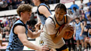 Garfield Heights' Marcus Johnson (right) covers up a rebound as Louisville's Ashton Marshall defends during an OHSAA Division III boys basketball state semifinal at Canton Memorial Field House on Sunday, March 16, 2025.