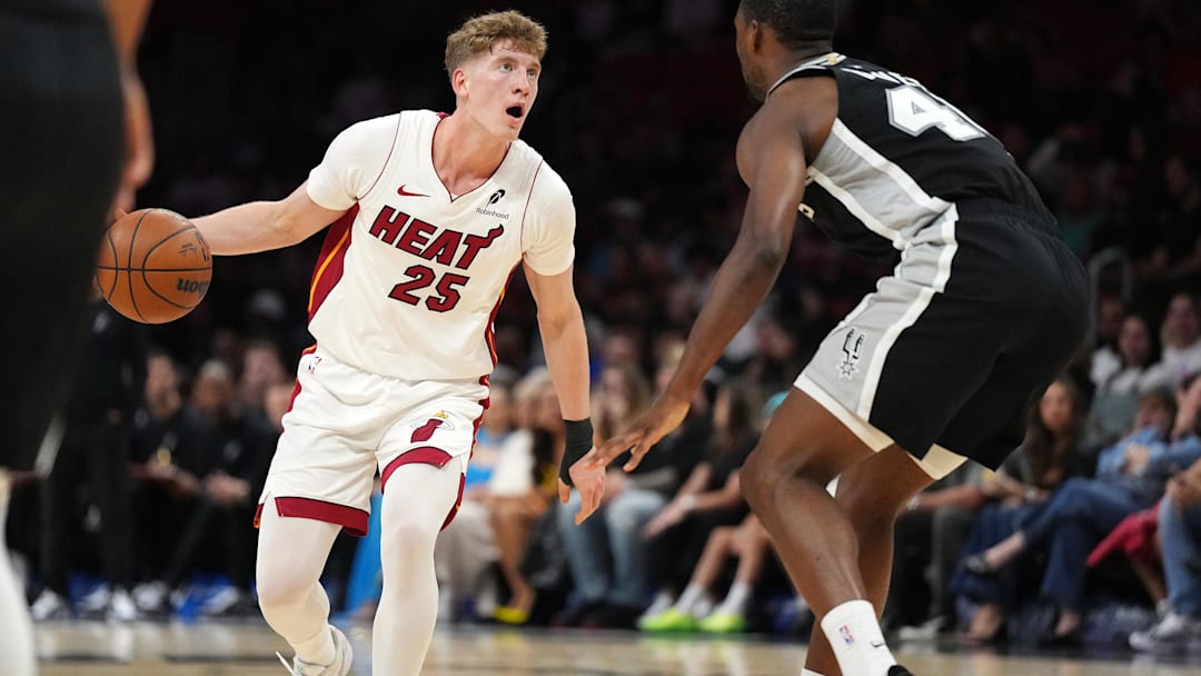 Oct 8, 2025; Miami, Florida, USA;  Miami Heat guard Kasparas Jakucionis (25) looks to pass the ball as San Antonio Spurs forward Harrison Barnes (40) defends in the first half at Kaseya Center. Mandatory Credit: Jim Rassol-Imagn Images