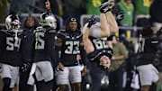 Nov 30, 2024; Eugene, Oregon, USA; Oregon Ducks linebacker Bryce Boettcher (28) does a back flip during a break in the second half against the Washington Huskies at Autzen Stadium. Mandatory Credit: Troy Wayrynen-Imagn Images