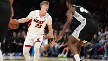 Oct 8, 2025; Miami, Florida, USA;  Miami Heat guard Kasparas Jakucionis (25) looks to pass the ball as San Antonio Spurs forward Harrison Barnes (40) defends in the first half at Kaseya Center. Mandatory Credit: Jim Rassol-Imagn Images