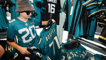Dalton Clowers makes his selections of throwback jerseys in the Pro Shop shortly after it opened Thursday morning. The Jacksonville Jaguars unveiled the team's new throwback jerseys Thursday morning, July 18, 2024 during a reveal at the Miller Electric Center near EverBank Stadium. 