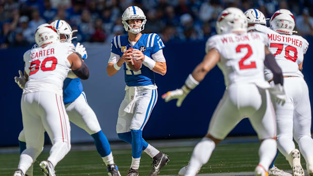 Colts quarterback Daniel Jones (blue and white jersey) gets ready to throw a pass against the Arizona Cardinals.