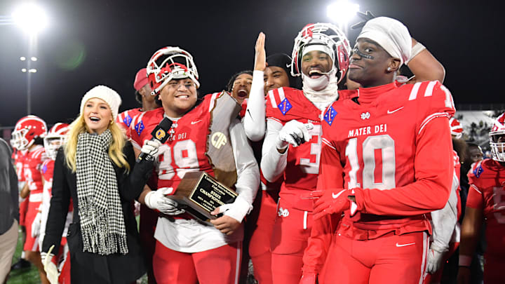 Mater Dei football players are all smiles with the 2024 CIF State Open Division trophy after beating De La Salle 37-15 at Saddleback College.
