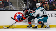 Coachella Valley forward Luke Henman (10) chases down the puck under pressure from San Jose defenseman Valtteri Pulli (77) during the first period of their game at Acrisure Arena in Palm Desert, Calif., Wednesday, Nov. 29, 2023.
