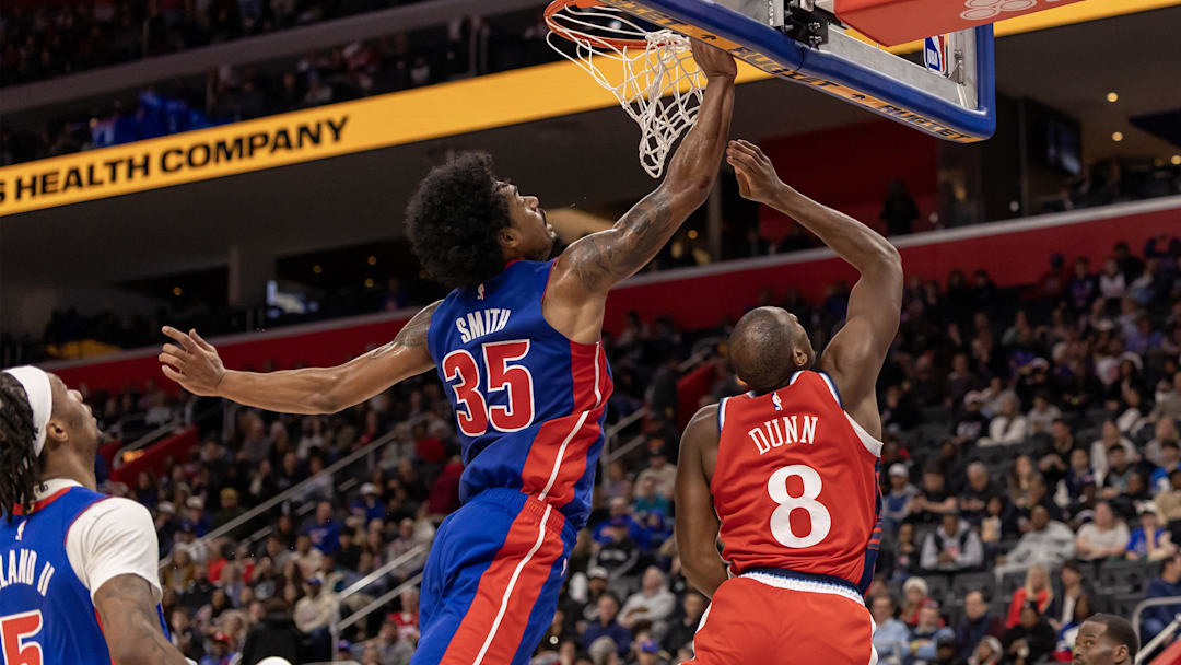 Jan 10, 2026; Detroit, Michigan, USA; LA Clippers guard Kris Dunn (8) drives to the basket for two points in front of Detroit Pistons forward Tolu Smith (35) during the second half at Little Caesars Arena. Mandatory Credit: David Reginek-Imagn Images