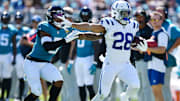 Indianapolis Colts running back Jonathan Taylor (28) pushes off Jacksonville Jaguars safety Andre Cisco (5) on a 40 yard pass play down the sideline during second quarter action. The Jacksonville Jaguars hosted the Indianapolis Colts at EverBank Stadium in Jacksonville, FL Sunday, October 15, 2023. The Jaguars ended the first half with a 21 to 6 lead. [Bob Self/Florida Times-Union]