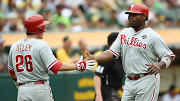 Utley and Howard dap each other up during a matchup against the Athletics.