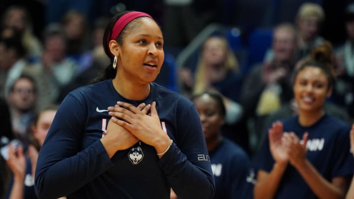 Former UConn Huskies player Maya Moore is honored before a game