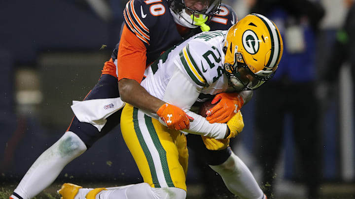 Jan 10, 2026; Chicago, IL, USA; Green Bay Packers cornerback Carrington Valentine (24) is tackled by Chicago Bears wide receiver Luther Burden III (10) after intercepting a pass during an NFC Wild Card Round game at Soldier Field.