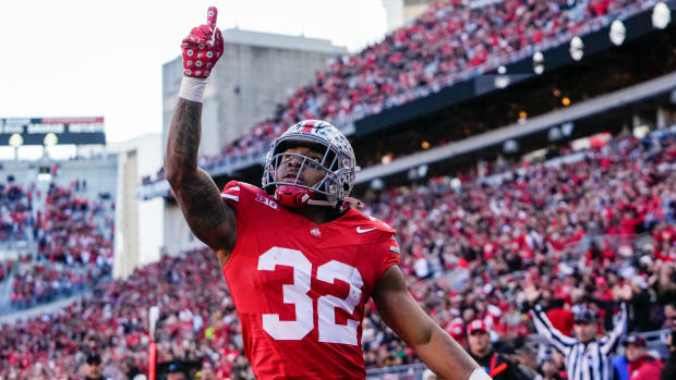 Ohio State Buckeyes running back TreVeyon Henderson celebrates a touchdown in a college football game in the Big Ten.