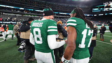 Jan 5, 2025; East Rutherford, New Jersey, USA; New York Jets quarterback Aaron Rodgers (8) and wide receiver Davante Adams (17) walk on the field after the Jets win over the Miami Dolphins at MetLife Stadium. Mandatory Credit: Ed Mulholland-Imagn Images