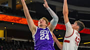 Grand Canyon forward Duke Brennan (24) jumps up for a basket while guarded by Stanford forward Maxime Raynaud (42) during the first half of their game in the Acrisure Series in Palm Desert, Calif., Tuesday, Nov. 26, 2024.