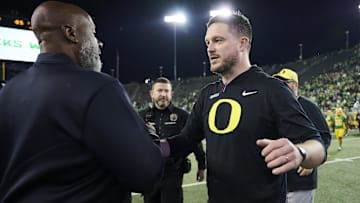 Nov 9, 2024; Eugene, Oregon, USA; Maryland Terrapins head coach Mike Locksley, left, congratulates Oregon Ducks head coach Dan Lanning after a game at Autzen Stadium. Mandatory Credit: Troy Wayrynen-Imagn Images