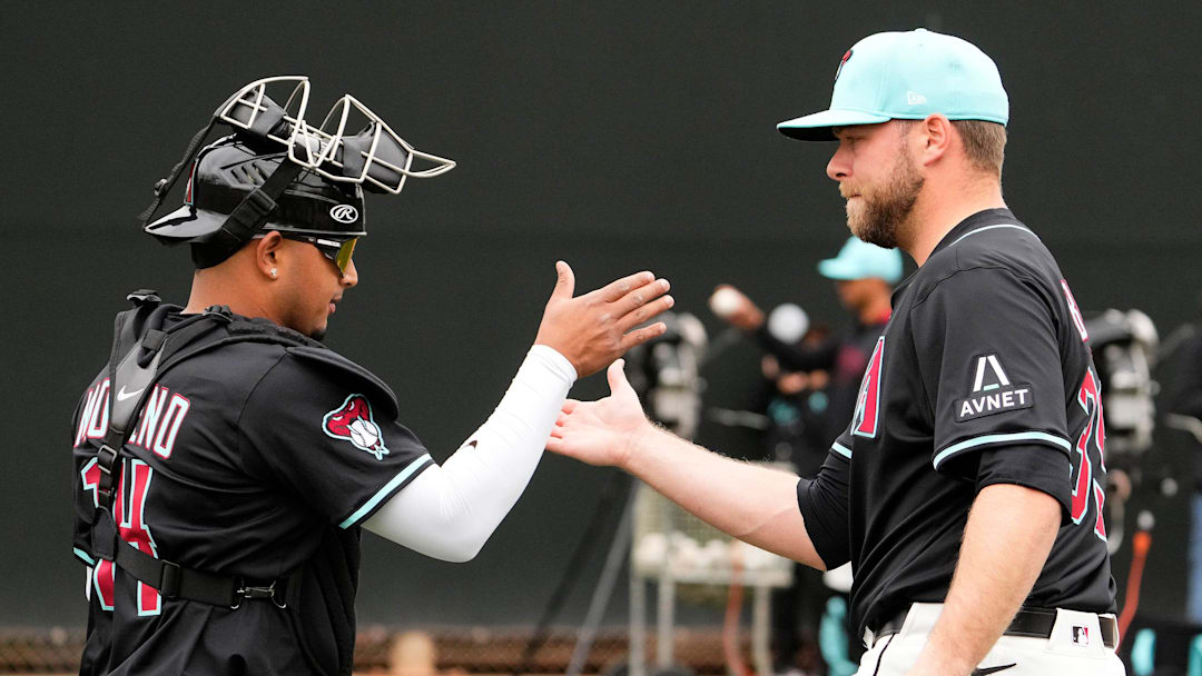 Arizona Diamondbacks catcher Gabriel Moreno greets new pitcher Corbin Burnes after throwing in the bullpen on the first day of spring training practice at Salt River Fields at Talking Stick in Scottsdale on Feb. 12, 2025.