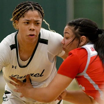 Canton South's Summer Hastings-Peterson tries to contain Laurel standout Saniyah Hall in the third quarter of OHSAA Division II District Semifinals at Nordonia High School. Wednesday, February 28, 2024.