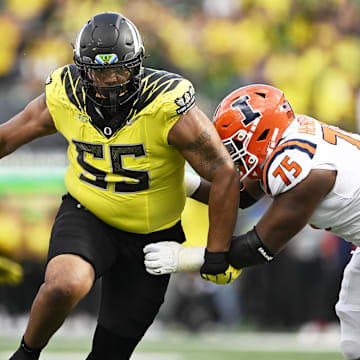 Oct 26, 2024; Eugene, Oregon, USA; Oregon Ducks defensive lineman Derrick Harmon (55) breaks past Illinois Fighting Illini offensive lineman Brandon Henderson (75) during the second half at Autzen Stadium. Mandatory Credit: Troy Wayrynen-Imagn Images