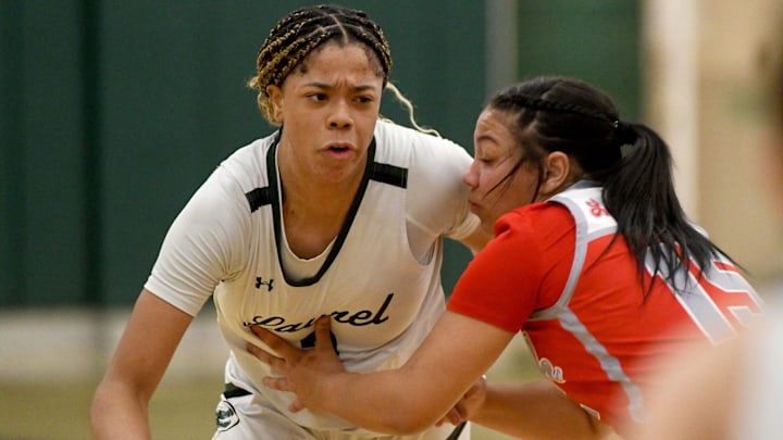 Canton South's Summer Hastings-Peterson tries to contain Laurel standout Saniyah Hall in the third quarter of OHSAA Division II District Semifinals at Nordonia High School. Wednesday, February 28, 2024. Canton South's Summer Hastings-Peterson tries to contain Laurel standout Saniyah Hall in the third quarter of OHSAA Division II District Semifinals at Nordonia High School. Wednesday, February 28, 2024.