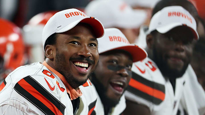 Cleveland Browns defensive end Myles Garrett (left) laughs as he watches a video on the scoreboard during the second quarter of a preseason football game against the Washington Redskins at FirstEnergy Stadium, Thursday, Aug. 8, 2019 in Cleveland, Ohio. [Jeff Lange/Beacon Journal/Ohio.com]