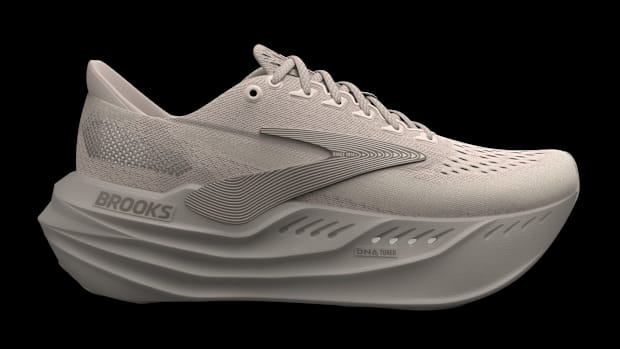 Side view of a tan Brooks Running shoe.