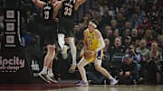 Feb 20, 2025; Portland, Oregon, USA; Los Angeles Lakers guard Austin Reaves (15) drives to the basket during the first half against Portland Trail Blazers center Donovan Clingan (23) and forward Toumani Camara (33) at Moda Center. Mandatory Credit: Troy Wayrynen-Imagn Images