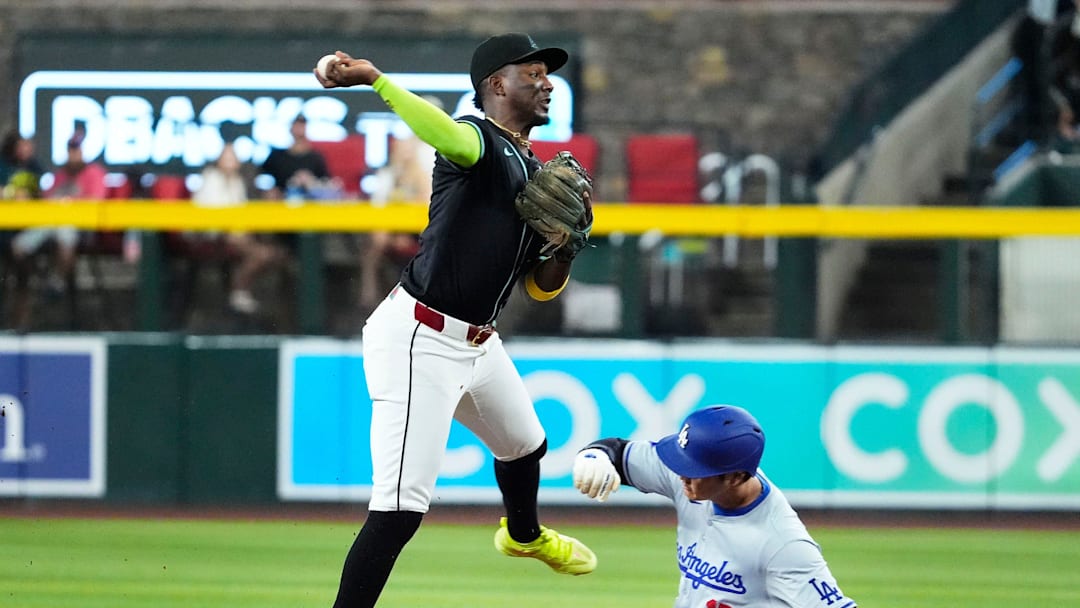 Arizona Diamondbacks shortstop Geraldo Perdomo (2) turns a double play against Los Angeles Dodgers Shohei Ohtani (17) in the first inning at Chase Field in Phoenix on Monday, Sept. 2, 2024.