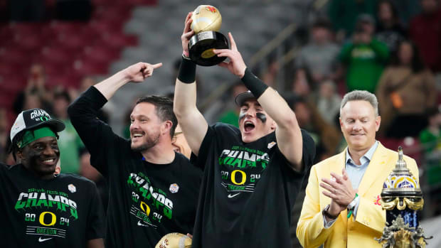 Oregon Ducks quarterback Bo Nix and head coach Dan Lanning celebrate after defeating the Liberty Flames in the Fiesta Bowl.