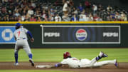 Arizona Diamondbacks Ketel Marte (4) slides into second base with a double against Chicago Cubs shortstop Dansby Swanson (7) in the third inning at Chase Field in Phoenix on April 17, 2024.