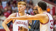 Indiana's Luke Goode (10) and Trey Galloway (32) talk with Mike Woodson against Purdue at Simon Skjodt Assembly Hall.