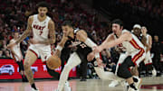 Jan 11, 2025; Portland, Oregon, USA; Portland Trail Blazers forward Toumani Camara (33) controls a loose ball during the second half against Miami Heat guard Jaime Jaquez Jr. (11) and center Kel'el Ware (7) at Moda Center. Mandatory Credit: Troy Wayrynen-Imagn Images