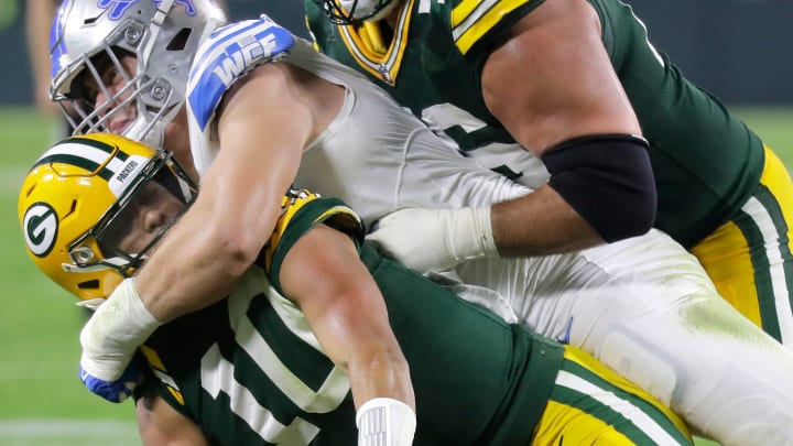 Detroit Lions offensive tackle Dan Skipper (70) tackles Green Bay Packers quarterback Jordan Love (10) 