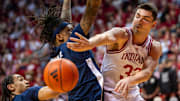 Indiana's Trey Galloway (32) passes around Penn State's Nick Kern Jr. (3) during Wednesday's 83-78 win.