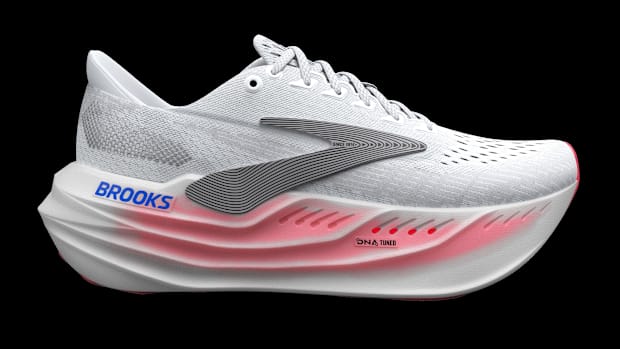 Side view of a white and black Brooks Running shoe.