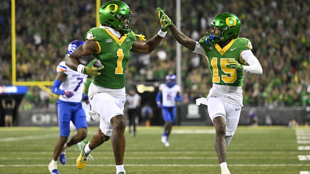 Sep 7, 2024; Eugene, Oregon, USA; Oregon Ducks wide receiver Traeshon Holden (1) high-fives wide receiver Tez Johnson (15) as he scores a touchdown during the second half against the Boise State Broncos at Autzen Stadium. Mandatory Credit: Troy Wayrynen-Imagn Images