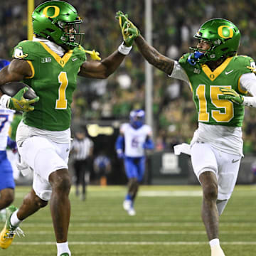 Sep 7, 2024; Eugene, Oregon, USA; Oregon Ducks wide receiver Traeshon Holden (1) high-fives wide receiver Tez Johnson (15) as he scores a touchdown during the second half against the Boise State Broncos at Autzen Stadium. Mandatory Credit: Troy Wayrynen-Imagn Images