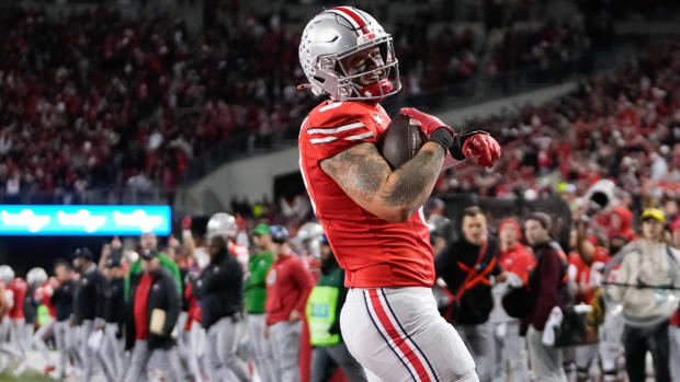 Tight end smiles in the end zone following a touchdown reception.