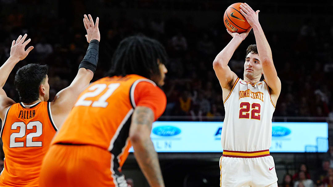Iowa State Cyclones forward Milan Momcilovic (22) takes a three-point shot over Oklahoma State Cowboys forward Parsa Fallah (22) and Oklahoma State Cowboys guard Isaiah Coleman (21) during the first half in the Big-12 men’s basketball on Jan. 10, 2026, at Hilton Coliseum in Ames, Iowa.