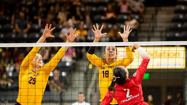 Arizona State Sun Devils middle blocker Maddie McLaughlin (25) and outside hitter Roberta Rabelo (18)