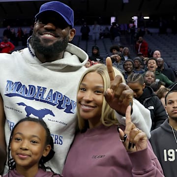 LeBron James, his wife Savannah, and daughter Zhuri with his son Bryce after the California (CIF) State Division 1 title game in Sacramento.