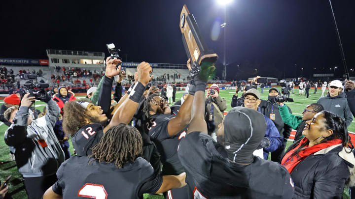 Imhotep Charter football players celebrate winning the 2023 PIAA Class 5A state championship over Peters Township.