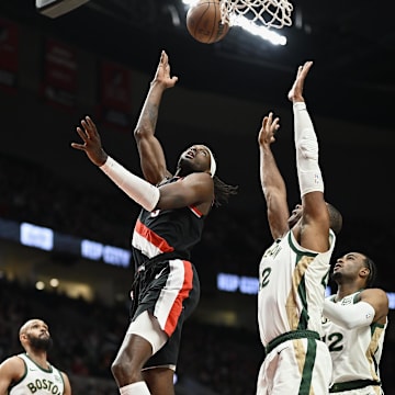 Mar 11, 2024; Portland, Oregon, USA; Portland Trail Blazers forward Jerami Grant (9) scores a basket during the first half against Boston Celtics center Al Horford (42) at Moda Center. Mandatory Credit: Troy Wayrynen-Imagn Images