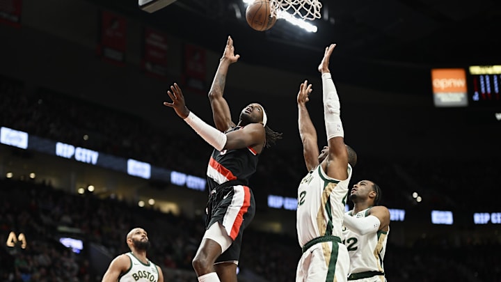 Mar 11, 2024; Portland, Oregon, USA; Portland Trail Blazers forward Jerami Grant (9) scores a basket during the first half against Boston Celtics center Al Horford (42) at Moda Center. Mandatory Credit: Troy Wayrynen-Imagn Images