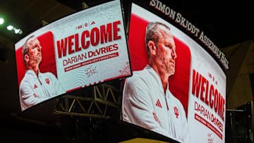 The video boards inside Simon Skjodt Assembly Hall display new men's basketball head coach Darian DeVries on Wednesday, March 19, 2025.