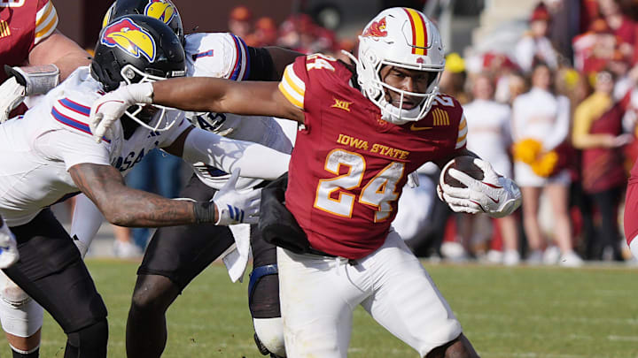 Iowa State Cyclones' running back Abu Sama III (24) breaks tackle from Kansas defenders as running for a first down during the fourth quarter in the senior day on Nov. 22, 2025, at Jack Trice Stadium in Ames, Iowa