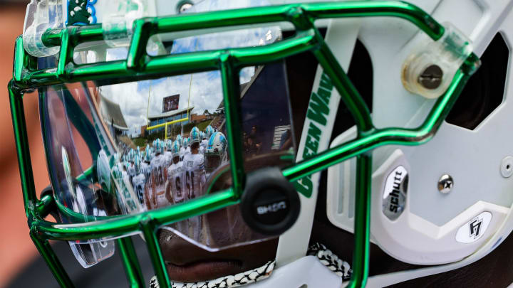 Oct 28, 2023; Houston, Texas, USA; The facemark of Tulane Green Wave defensive back Rayshawn Pleasant (25) reflects his teammates as he warms up before a game against the Rice Owls. 